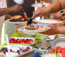 Guests filling plates at a summer cookout